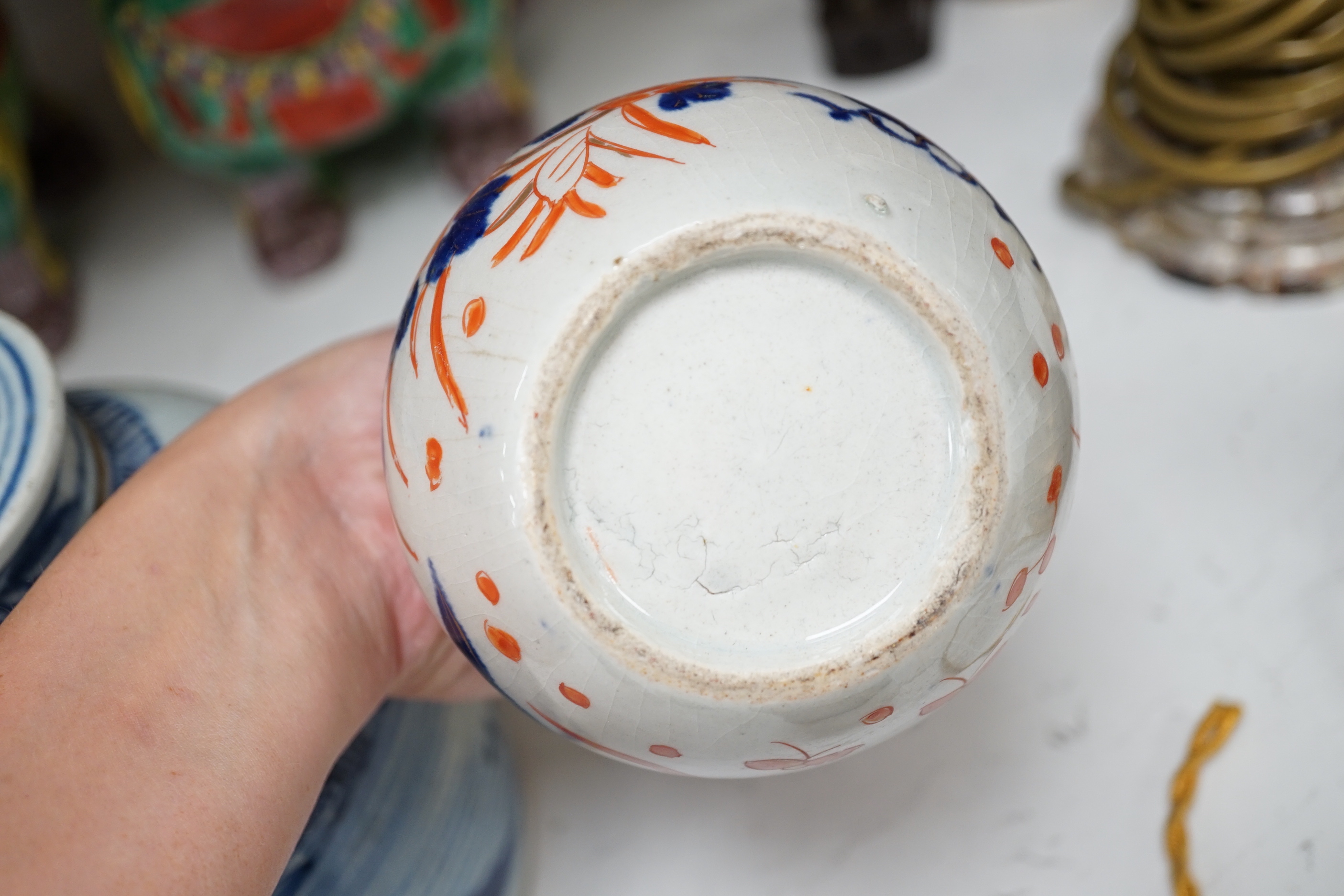 A collection of 20th century Chinese and Japanese ceramics including pair of Imari bottle neck vases, blue and white jar and cover and a pair of dog of foo pots and covers (one cover missing) together with two cloisonné